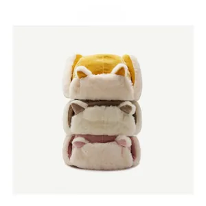 Three plush winter trapper hats with animal ears in yellow, brown, and pink corduroy