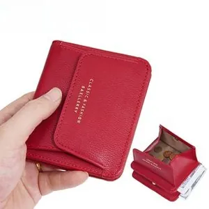Macro view of a red textured leather folding wallet with gold embossed lettering