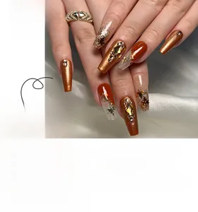 Detailed view of autumn-themed ballerina press-on nails with maple leaf and rhinestones