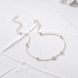 Macro detail of S925 sterling silver ball chain bracelet with a sparkling zircon stone