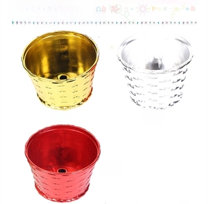 Detailed view of weave-textured Christmas tree stand pots in gold, silver, and red colors