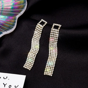Detailed macro view of long rhinestone tassel earrings with five-row crystal pavé Fringe