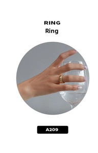 Macro view of gold plated croissant ring with ribbed texture worn by a model