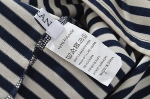 Detail of the 100% polyester fabric care label and striped pattern on the sleeve