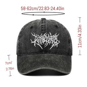 Detail of gothic white embroidery on washed black cotton distressed baseball cap