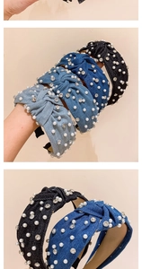 Detail of knotted denim headbands with rhinestones and white pearls in various blue tones