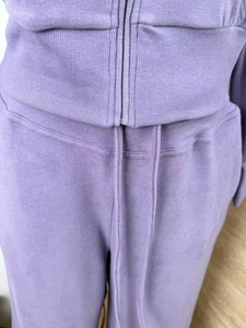 Detail view of purple lounge set showing stitching, zipper finish, and drawstring waist