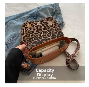 Detail of brown leather saddle bag interior showing leopard print and phone capacity