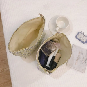 Detail of floral makeup bag showing zipper opening, spacious interior and lining