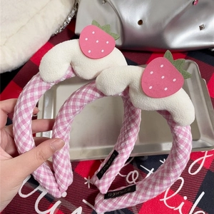 Pink checkered strawberry headbands featuring soft fabric and cute fruit decorations