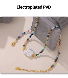 Macro detail of multicolored beads and square baroque pearl on 18k gold plated chain