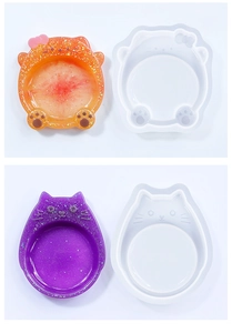 Detail view of cat-shaped silicone molds for DIY resin trays in orange and purple glitter