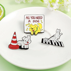 Close-up of cute cartoon cat and dog enamel badges on a white plate with floral decor