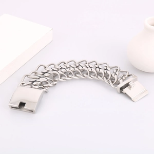 Macro detail of silver twist chain bracelet with black X-pattern and heavy box clasp