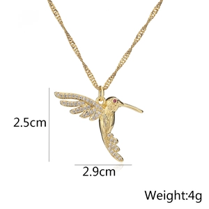 Detailed hummingbird pendant with 18K gold plating and cubic zirconia wing inlay