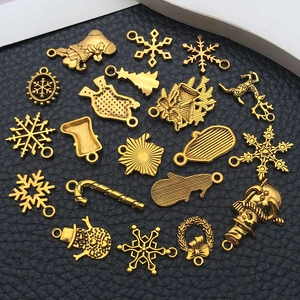 Detailed view of assorted antique gold Christmas charms for DIY jewelry making