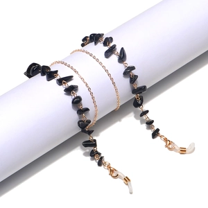 Detail of handmade black natural stone glasses chain with gold metal links and rubber ends