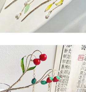 Detail of gold hairpins with enamel red cherries, strawberries and white pearls