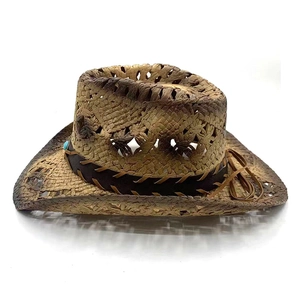 Detail of western straw hat with hollow pattern, leather band, and turquoise bead