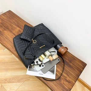 Black V-quilted leather tote bag with matching small purse and large interior capacity