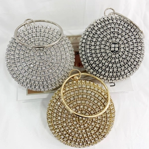 Detailed view of luxury rhinestone clutch bags with metal ring handles in three elegant colors
