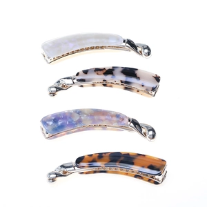 Set of four glossy acetate banana hair clips in pearl and tortoiseshell patterns
