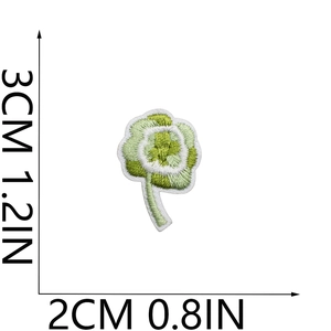 Detailed view of small green and white flower embroidery patch with size measurements