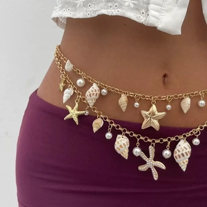 Detailed view of layered waist chain featuring golden starfish and sea shell charms