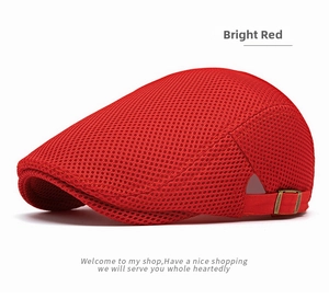 Detail view of bright red mesh flat cap showing the breathable texture and metal buckle