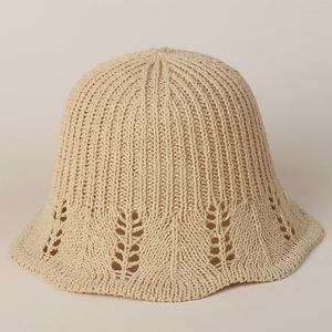 Detailed close-up of leaf-shaped hollow lace patterns on a beige crochet straw hat