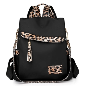 Women's leopard print nylon backpack with flap closure and tassels on white background