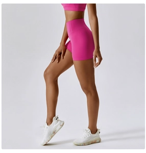 Detail view of high-waist rose pink yoga shorts and sports bra for fitness workout