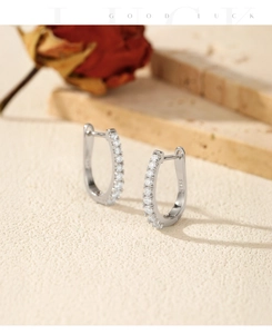 Close-up of S925 sterling silver U-shaped earrings with sparkling moissanite stones