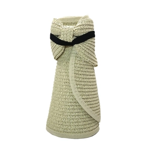 Close-up of foldable woven sun hat texture in beige showing portable storage design