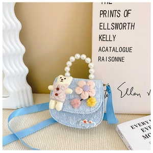 Detail of light blue floral jacquard girl purse with plush bear and pearl handle
