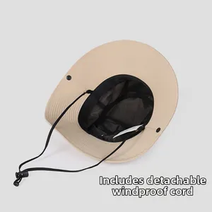 Detail of beige sun hat featuring breathable mesh lining and a detachable black chin strap