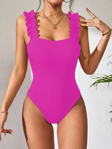 Close-up of fuchsia ribbed knit bodysuit featuring ruffled straps and a square neckline