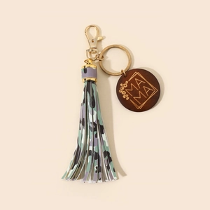 Close-up of leopard print tassel keychain with gold MAMA engraved wooden disc charm