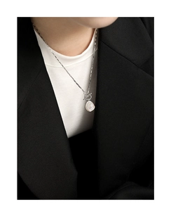 Close-up of S925 sterling silver chain with baroque pearl and stylish OT toggle clasp