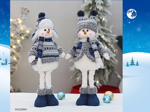 Detail of blue plush Christmas snowmen with knitted hats and scarves on festive background