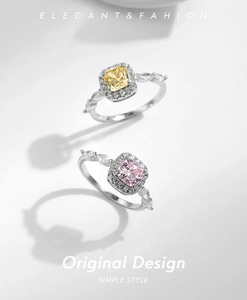 Macro detail of halo-set cushion cut yellow and pink crystal rings in s925 silver
