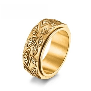 Detail view of gold stainless steel spinning ring with embossed eyeball relief patterns