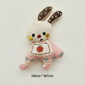 Detailed view of handmade embroidered rabbit doll with sizing 9cm height and 7cm width