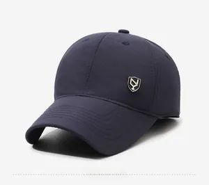Detail view of the navy blue winter baseball cap featuring a metal shield logo and curved brim