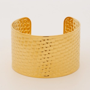 Detailed close-up of golden hollow cuff bracelet with textured weave pattern design