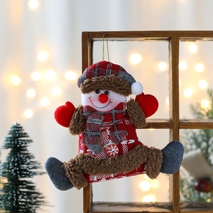 Hanging Christmas snowman ornament with red checkered fabric on a wooden festive background