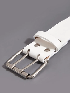 Close-up of a white leather belt featuring silver metal double grommets and a pin buckle