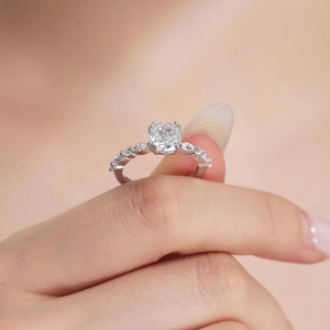 Macro shot of a sparkling cushion cut zircon ring with marquise stones on a silver band
