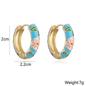 Detail of 2.2cm blue enamel hoop earrings with pink flower patterns and 18K gold base