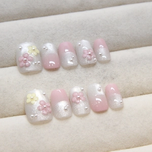 Handmade cat-eye press-on nails with 3D pink flowers and pearls on soft pink base